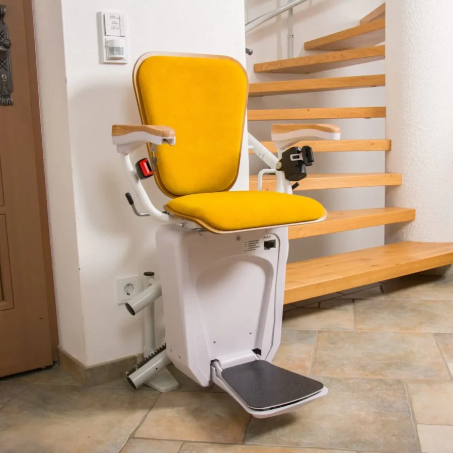 Lehner Alpha curved stairlift at the lower landing of a curved staircase