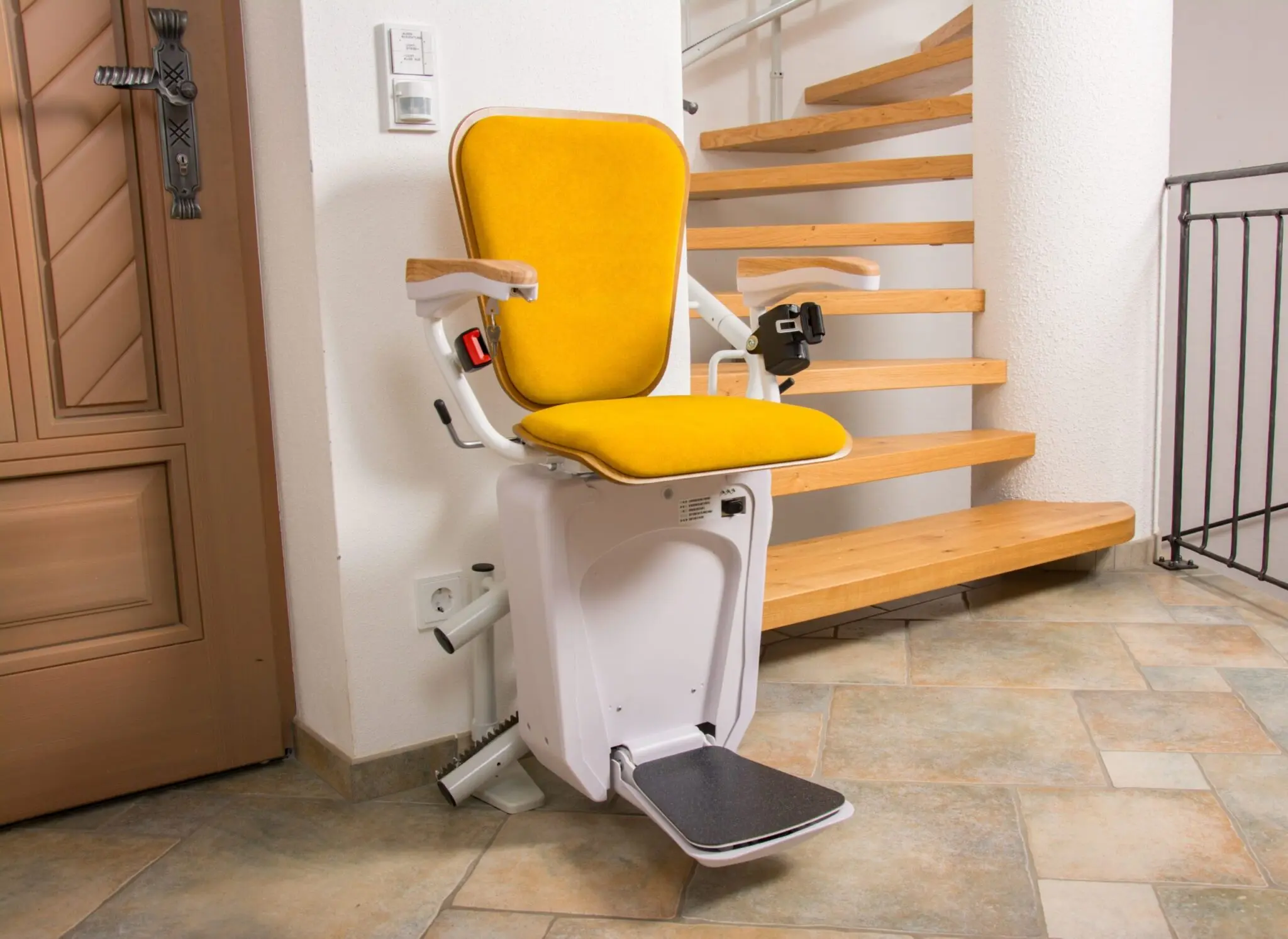 Lehner Alpha curved stairlift at the lower landing of a curved staircase