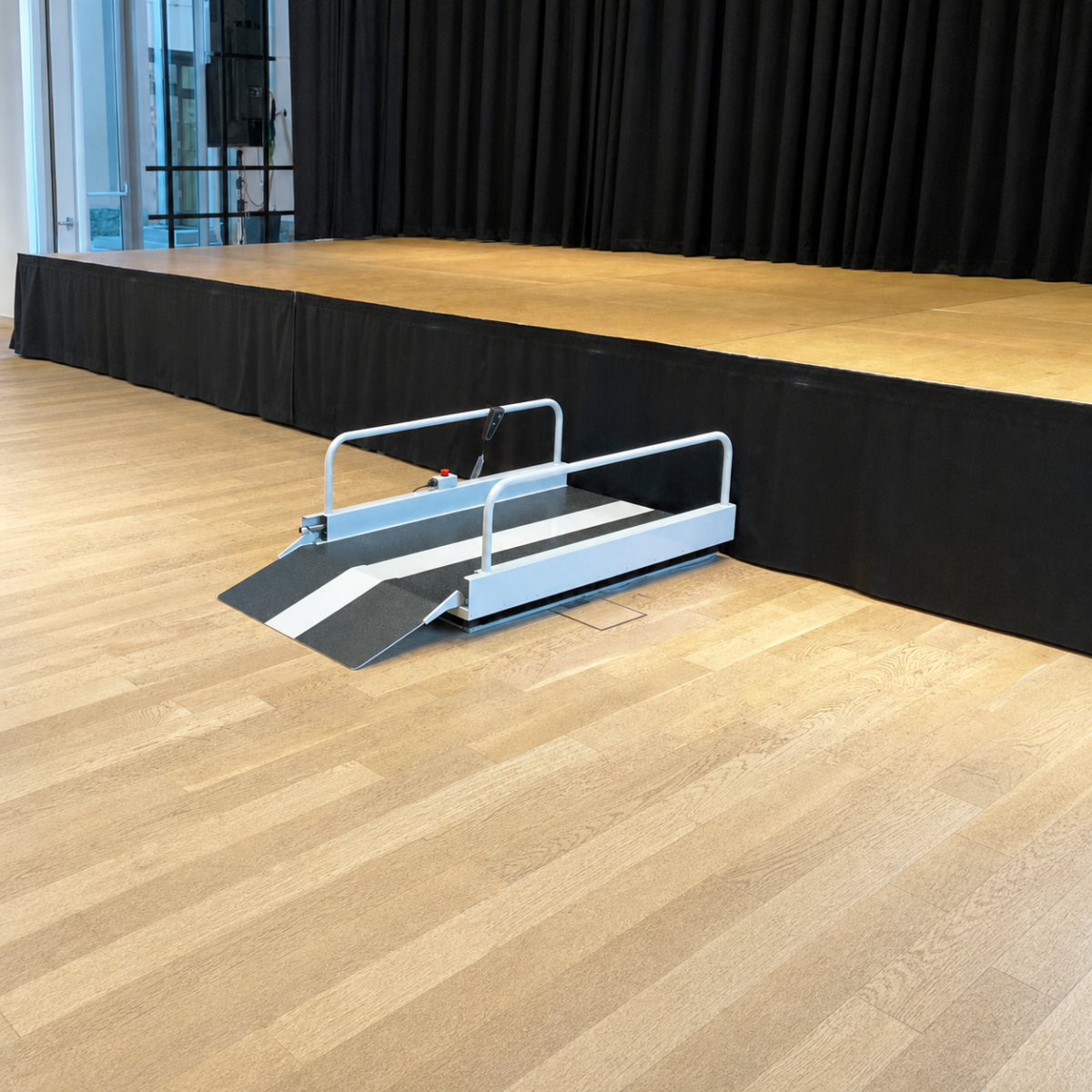 Liftboy 1 2 3 low-rise lifting platform beside an indoor stage