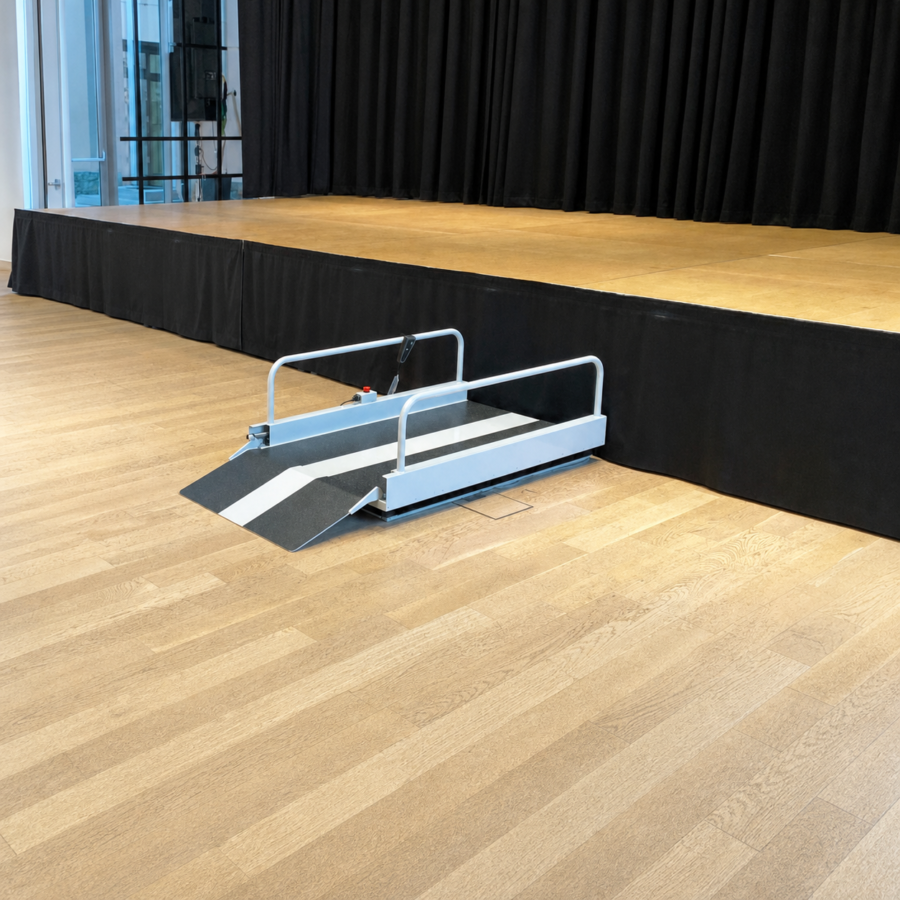 Liftboy 1 2 3 low-rise lifting platform beside an indoor stage
